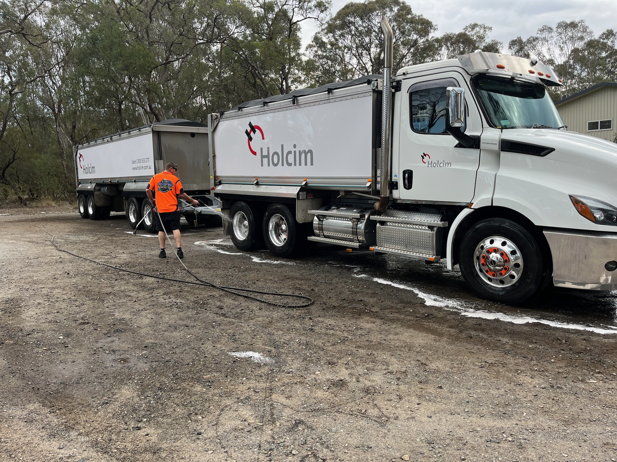 Proshine team washing a commercial truck and trailer on site